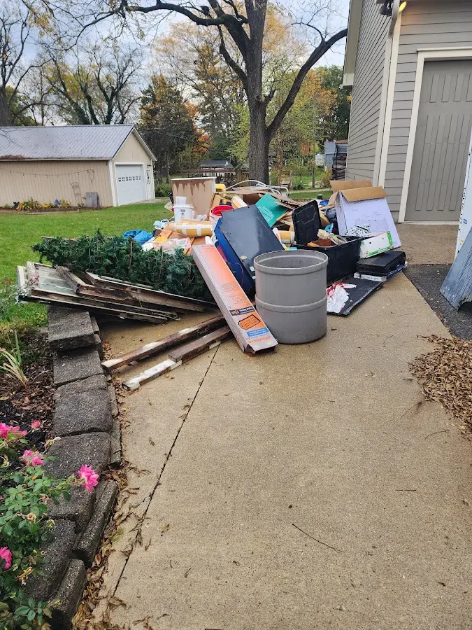 Dumpster being loaded with debris for Estate Cleanout Dumpster Rental in San Diego